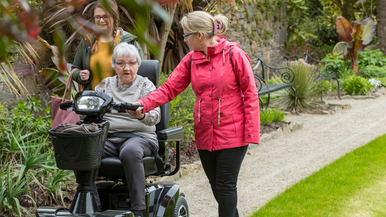 Family Walking through Sunken Garden with Mobility Scooter
